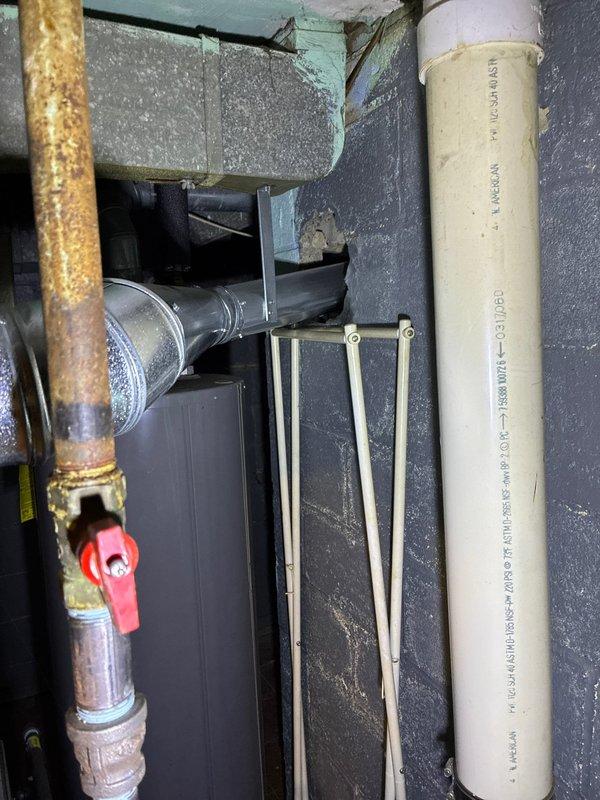 Conducted site assessment for AC replacement options as existing unit has been non-operational for extended period. Documented exterior utility connections and electrical service equipment. Inspected mechanical room revealing corroded copper piping with valve and ventilation ductwork. Noted furnace is relatively new and in good working condition.