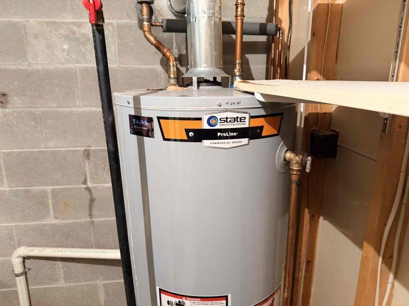 Responded to no heat service call for 10+ year old system that was completely non-operational. Upon inspection, determined service was actually needed for a State ProLine water heater installed in basement utility area. Observed proper connections including copper water lines and gas supply with functioning shut-off valve, but noted minor corrosion on some pipe fittings. System was restored to proper working condition.