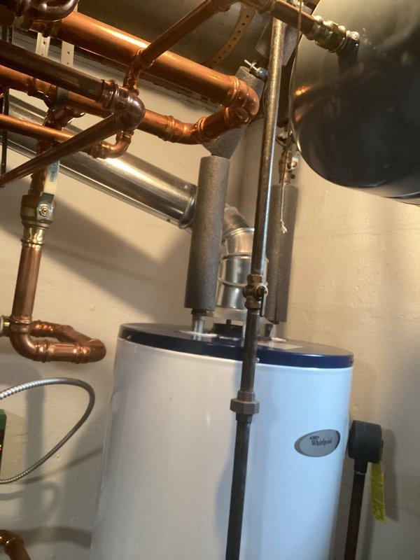 Performed regular maintenance service on Whirlpool tanked water heater system. Inspected all copper pipe connections, ventilation components, and control panel for proper functionality. Unit is operating within normal parameters with no leaks or issues detected at connections or tank base.