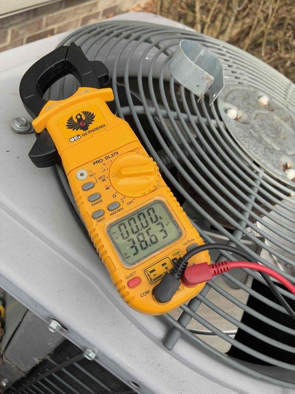 Responded to emergency no-cool call for central air system under 5 years old that was incorrectly running after attempted shutdown. Diagnostic testing with UEI Phoenix PRO-DL379 clamp meter revealed failed dual-run capacitor (40/5μF ±6% CBB65, 440V AC). Replaced defective capacitor and verified proper system operation with normal amperage readings.