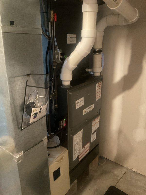 Performed routine heating maintenance on residential HVAC system, including inspection of furnace unit with PVC venting and adjacent air handler. System was found to be in proper working condition with no issues identified during the service visit.