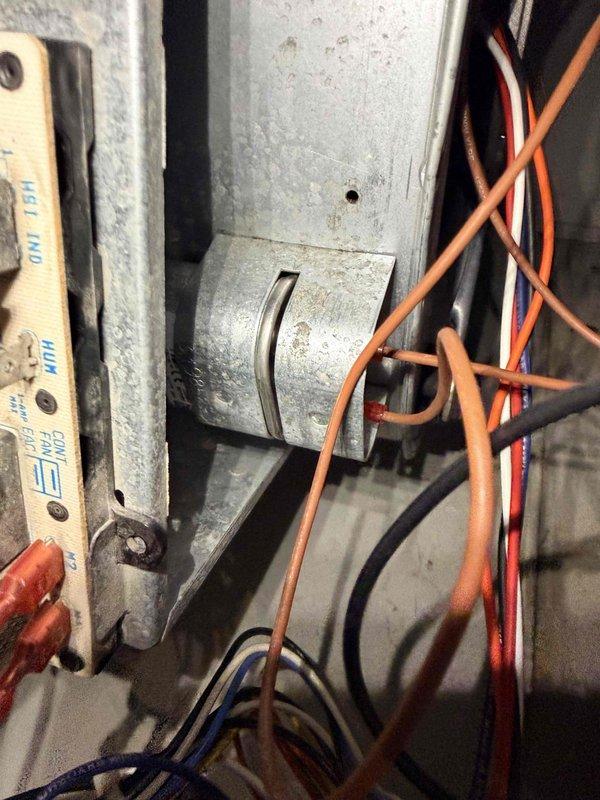 Performed routine heating maintenance on system. Inspected fan motor assembly and electrical connections, confirming proper wire routing through mounting bracket. All components appear to be in normal working condition with no signs of damage or abnormal wear.