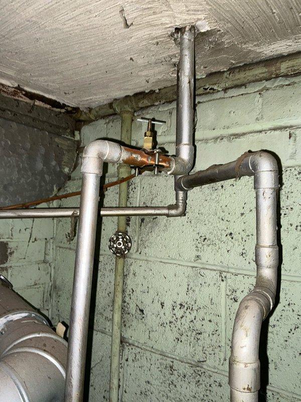 Conducted comprehensive assessment of existing plumbing system in utility area, documenting aging galvanized pipes with visible corrosion and deteriorating connections. Presented customer with multiple replacement options for both furnace-only and complete HVAC system solutions, along with available repair alternatives for the current installation.