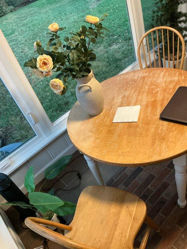 Conducted site assessment for mini split installation options in customer's seasons room, which features exposed brick walls and multiple windows. Evaluated space requirements and potential mounting locations to provide appropriate cooling/heating solution for this dining area with brick flooring and large windows overlooking lawn.