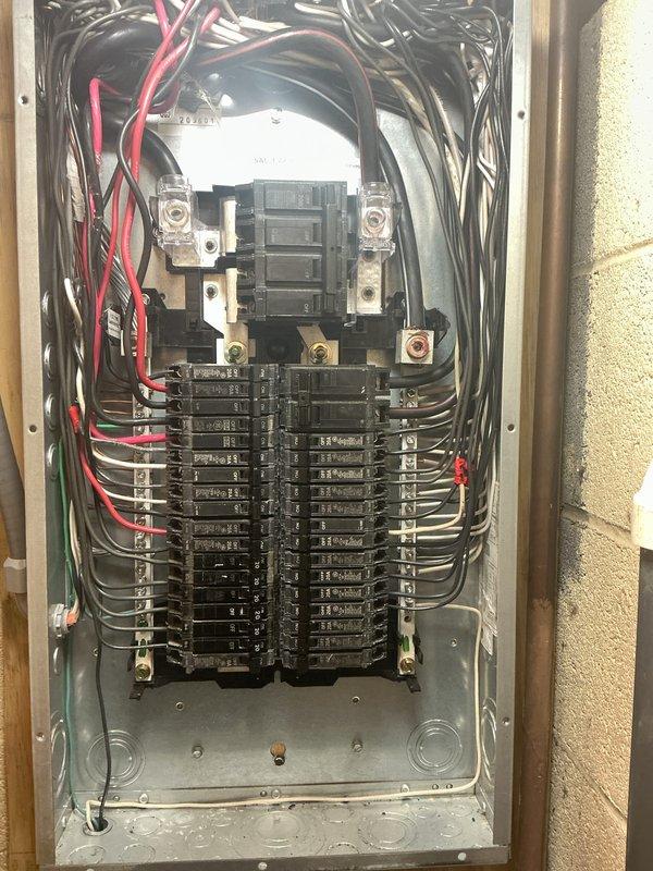 Conducted comprehensive electrical inspection of a residential installation featuring a Generac transfer switch and digital electric meter mounted on the exterior wall, with all components connected via proper conduit piping. Interior inspection of the circuit breaker panel revealed standard configuration with main breaker and multiple circuits, with all wiring connections appearing to be in good working condition. Photographic documentation was completed for service records.