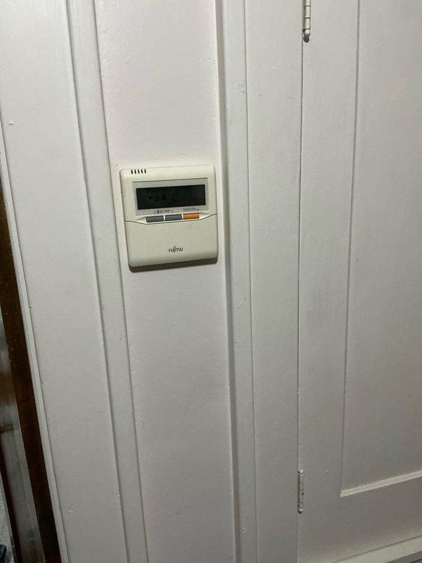 Conducted site assessment for ductless mini-split replacement options. Inspected existing Fujitsu wall-mounted thermostat and evaluated current ductwork condition in attic space. Documented insulated metal ducts and structural considerations for potential system conversion.