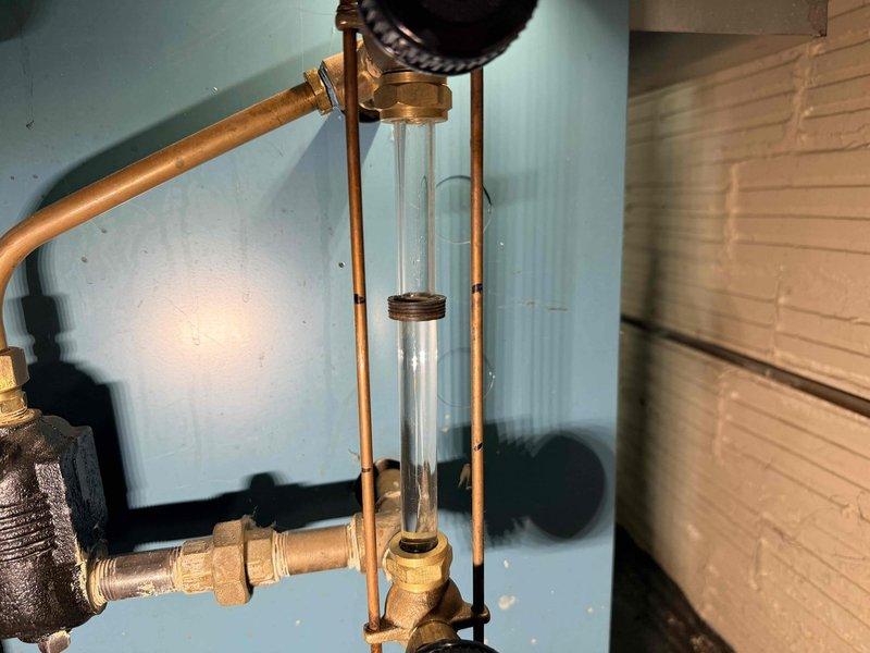 Responded to customer call regarding water leakage from boiler system. Upon inspection, identified compromised sight glass component in the hydronic loop as the source of the leak. Replaced sight glass assembly and checked system pressure, confirming proper operation with no further leakage observed.