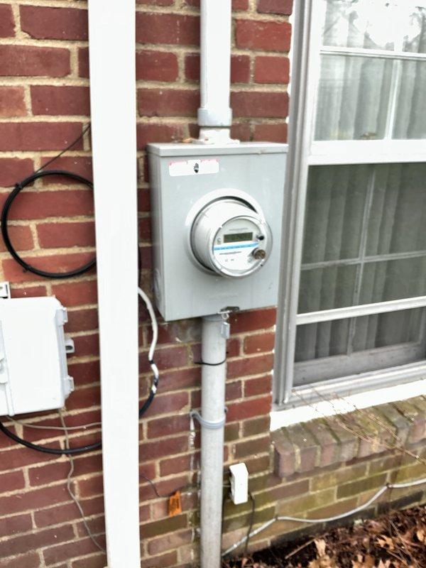 Performed electrical inspection of residential service entrance components and main distribution panel. Examined exterior meter installation on brick facade, verifying proper conduit connections and mounting. Inspected interior circuit breaker panel, evaluating breaker condition, wire routing, and overall system integrity.