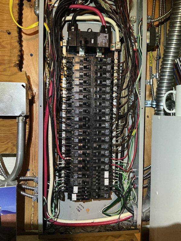 Performed electrical inspection of residential service entrance components and main distribution panel. Examined exterior meter installation on brick facade, verifying proper conduit connections and mounting. Inspected interior circuit breaker panel, evaluating breaker condition, wire routing, and overall system integrity.