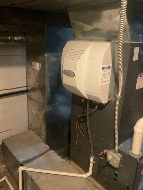 Performed routine maintenance service on Goodman heating system with attached humidifier. Inspected all components including ventilation system, PVC piping, and electrical connections. System functioning properly with no issues identified.