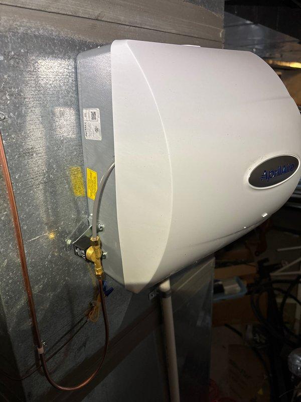 Successfully installed new furnace with dual 2410 humidifiers. Complete installation included proper mounting of Aprilaire humidifier to ductwork with brass water supply valve and connection of galvanized metal ductwork to the central air handler. All components were properly secured with appropriate warning labels applied.