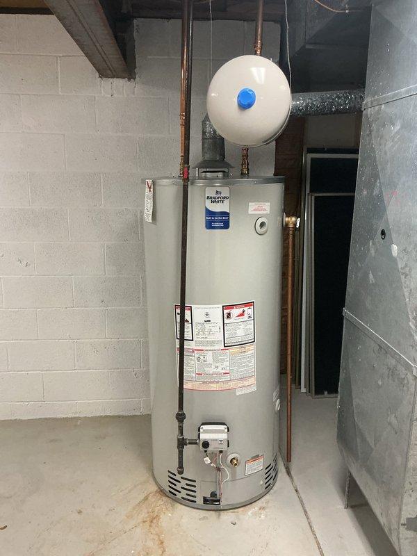 Completed hot water tank flush and fill service on residential tanked water heater. Inspected system components including expansion tank and copper supply lines. Unit is functioning properly with no leaks or damage observed.