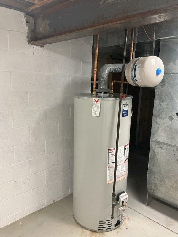 Completed hot water tank flush and fill service on residential tanked water heater. Inspected system components including expansion tank and copper supply lines. Unit is functioning properly with no leaks or damage observed.