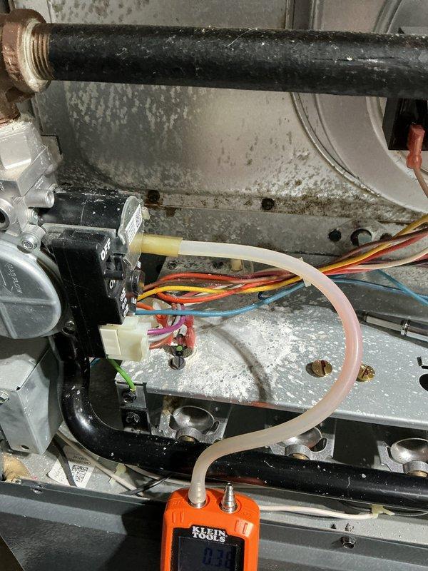 Performed routine maintenance on Goodman heating system. Conducted pressure testing with Klein differential manometer, recording static pressure readings at 0.0 and 350. Inspected interior components including electrical connections, control module wiring, and verified proper system operation.