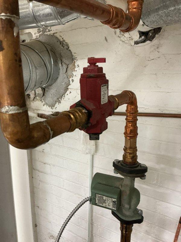 Performed scheduled maintenance service on dual heating systems, including inspection and testing of water boiler and furnace components. Verified proper operation of circulation pump, checked valve functionality, and examined copper piping network for leaks or corrosion issues. Noted minor discoloration at wall junction requiring future monitoring but systems are operating within normal parameters.