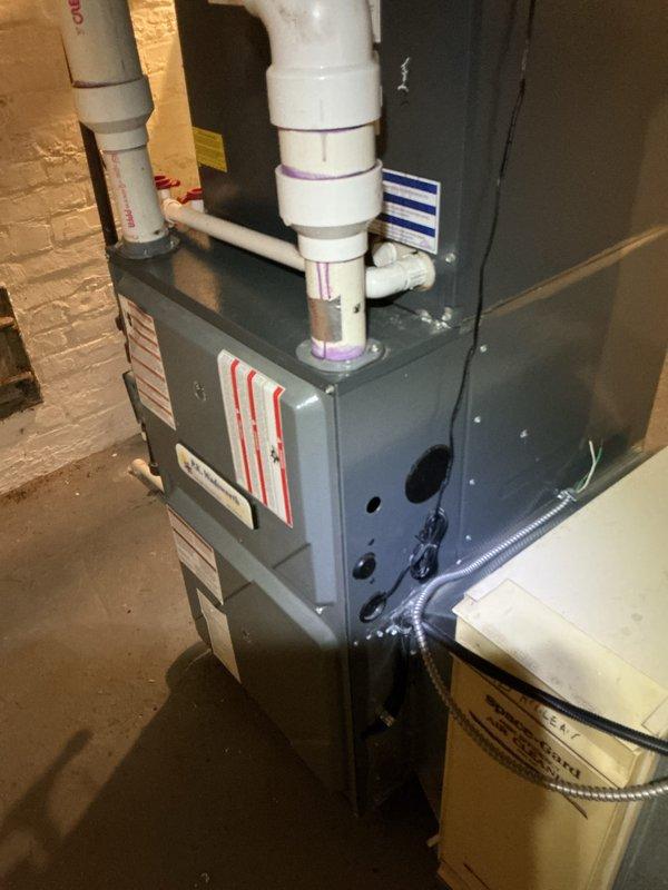 Performed scheduled preventative maintenance on residential furnace system. Inspected Clean Comfort humidifier unit mounted to ductwork and verified proper connection to the HVAC system. Examined furnace with PVC intake/exhaust venting, confirming all connections were secure with appropriate primer at joints.