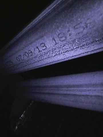 Performed routine maintenance on a 10+ year old heating system, inspecting the burner assembly and heat exchanger. System appears to be from July 2013 based on manufacturer date stamp, showing normal wear but remaining in operational condition. Documented current state with photos for service records.