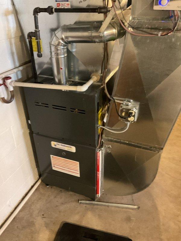 Performed routine heating system maintenance on a residential furnace unit with connected ductwork and ventilation components. Inspected control panel functionality, gas line connections, and overall system operation. All components found to be in proper working order with no issues identified.