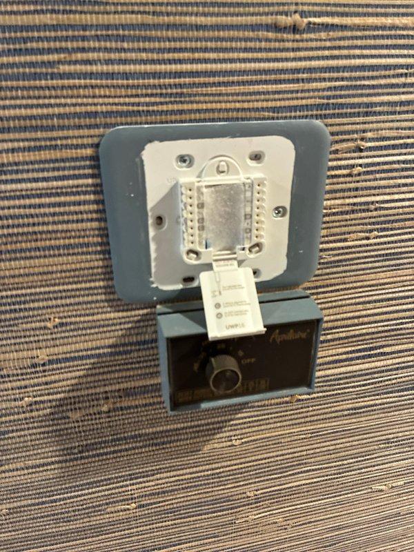 Conducted assessment of 18-year-old HVAC system at slab home with easy access. Inspected existing outdoor AC unit mounted on concrete pad with electrical disconnect box and meter. Examined thermostat wiring and connections, noting system age and customer's report of insufficient heating during winter months. Provided replacement options for both furnace and complete system.