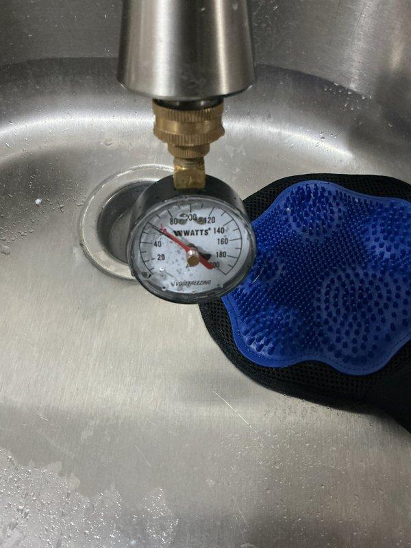 Completed afternoon plumbing inspection of bathroom sink installation, including undermount porcelain basin with brushed nickel faucet. Performed water pressure testing using Watts gauge, with readings measuring approximately 80-90 PSI. All fixtures and connections were verified to be functioning properly with no leaks detected.