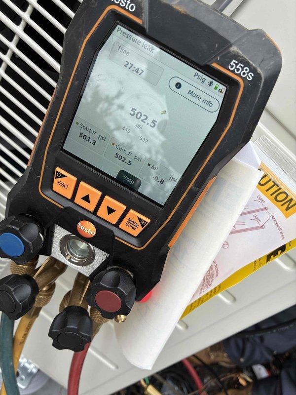 Completed installation of a 5-head mini-split system with 2 Daikin condensers mounted on concrete pads. Performed pressure testing with Testo 568s digital gauge to verify system integrity, achieving 502.5 psi during leak detection procedures. System was properly installed with coordination with electrical contractor for final connections.