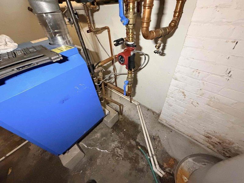 Responded to no-heat call for a relatively new boiler system. Diagnosed communication failure between thermostat and boiler control unit. Observed normal blue flame operation at burners but detected significant corrosion along the heat exchanger, indicating possible condensate drainage issues affecting electrical components. Restored communication functionality and verified proper system operation.