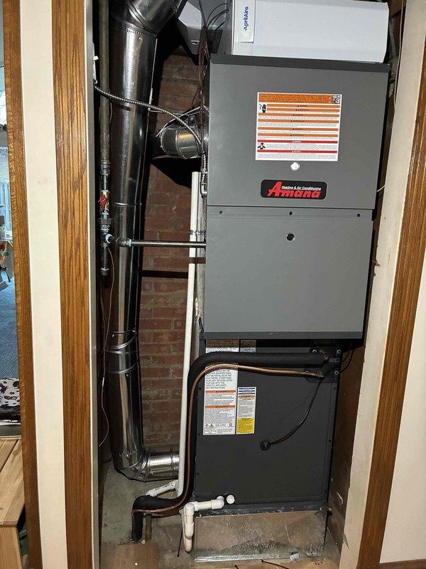 Successfully completed installation of a new Amana furnace and AC system with humidifier and chimney liner. Verified proper electrical connections with appropriate 30A Littelfuse fuses in the fuse block. System was installed with proper ductwork, exhaust venting, and drainage components according to manufacturer specifications.