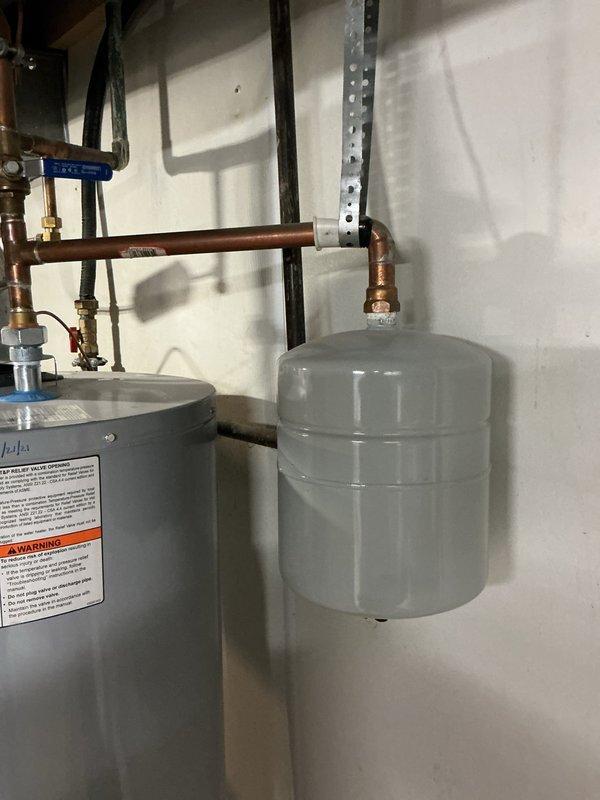 Performed routine maintenance on an 8-gallon tanked water heater system. Inspection revealed copper pipe oxidation with significant bluish-green patina formation. System components including expansion tank, shutoff valves, and brass fittings were verified to be in proper working condition with no active leaks detected.