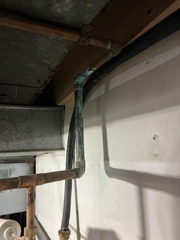 Performed routine maintenance on an 8-gallon tanked water heater system. Inspection revealed copper pipe oxidation with significant bluish-green patina formation. System components including expansion tank, shutoff valves, and brass fittings were verified to be in proper working condition with no active leaks detected.