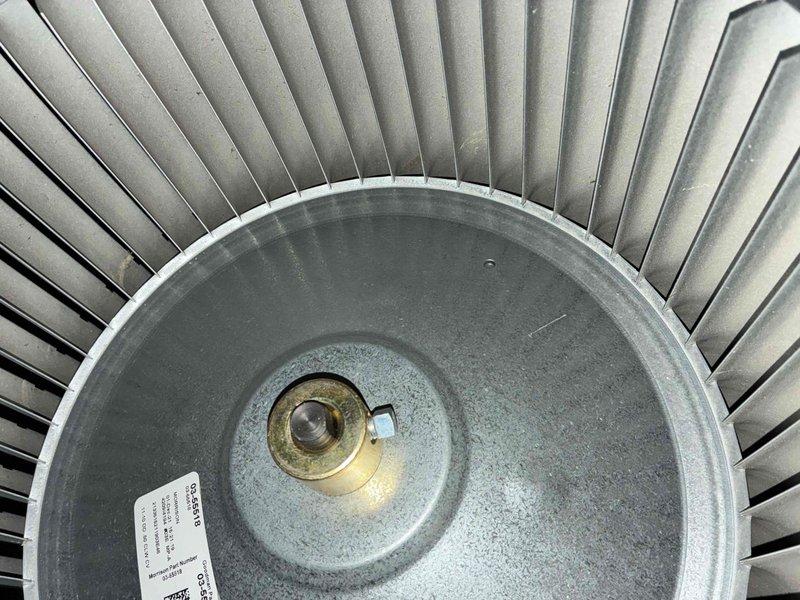 Performed routine heating system maintenance service on furnace. Inspected blower wheel assembly for proper operation and cleaned visible corrosion from central mounting hardware. Conducted electrical diagnostics with digital multimeter, verifying current readings of 0.163 and 0.003 amps on system components to ensure proper electrical function.