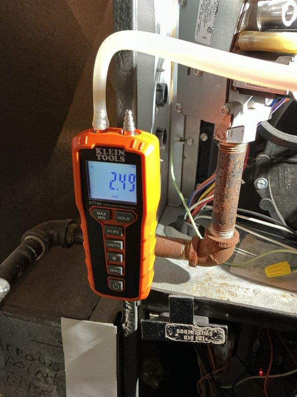 Performed scheduled heating maintenance service on furnace system. Inspected internal components including blower motor, wiring connections, and electrical assemblies. Conducted gas pressure testing with digital manometer showing 2.43" WC, confirming system is operating within manufacturer specifications.