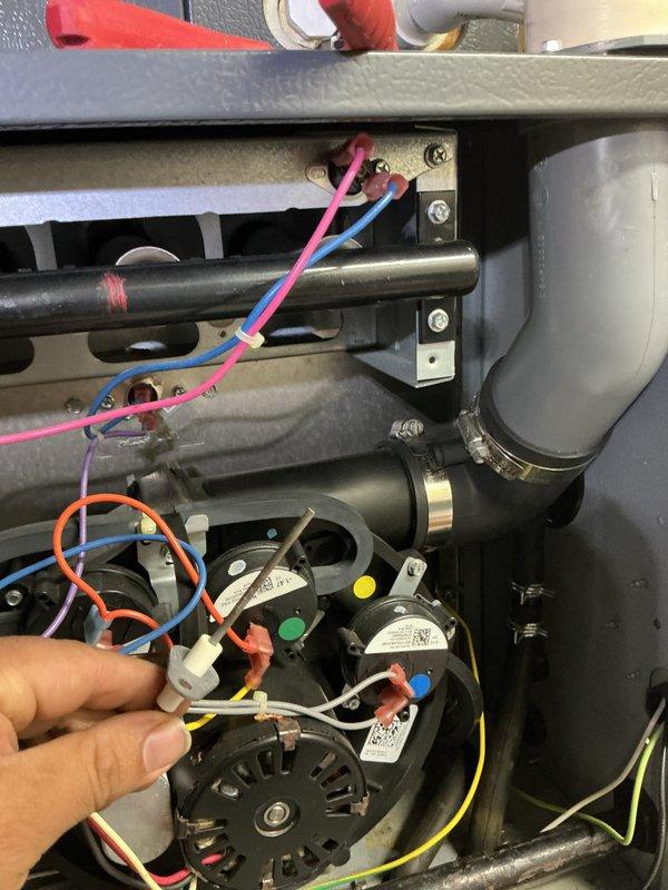 Performed routine heating maintenance on existing system; inspected electrical connections and wiring integrity within control panel. Verified proper operation of motor assembly and checked condition of metal casing which showed signs of previous repair at lower edge.