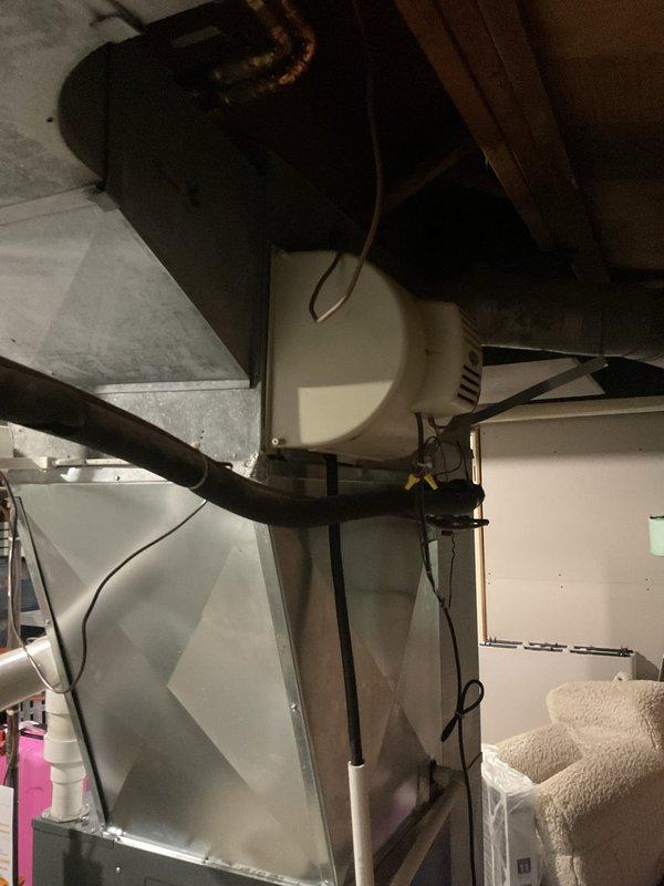 Performed routine heating maintenance on residential furnace system. Inspected internal electronic components and wiring with access panel open, and verified proper installation of PVC exhaust/intake piping. Checked connected humidifier mounted to ductwork and examined copper line connections to ensure system functionality.