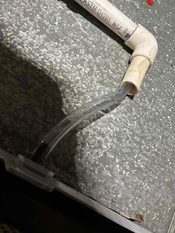 Successfully installed AprilAire Model 60 humidifier system with PVC drainage piping and clear tubing for proper water flow. Unit was calibrated, tested, and confirmed operational with humidistat displaying 32% relative humidity and green "Humidifier On" indicator illuminated.