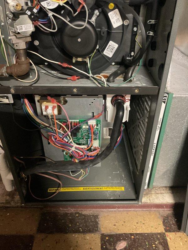 Performed routine maintenance on residential furnace system, inspecting blower motor assembly, circuit board connections, and gas valve components. Verified all electrical connections were secure with proper wire routing, and confirmed ventilation system was functioning correctly. No issues identified during comprehensive inspection; system is operating within normal parameters.