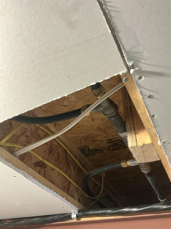 Responded to service call for multiple plumbing issues. Performed diagnostic inspection of continuously running toilet and identified leak source. Accessed ceiling panel to inspect plumbing infrastructure and examined Prestige tankless water heater experiencing error codes when kitchen faucet was in use. Repaired disconnected drain stopper in master bathroom.