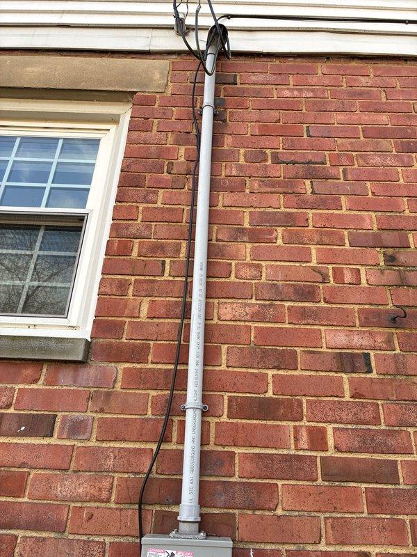 Conducted site assessment for furnace replacement options. Inspected exterior electrical connections housed in PVC conduit mounted to brick exterior wall. Evaluated utility area containing A.O. Smith ProLine water heater with associated exhaust venting and plumbing infrastructure. Presented repair alternatives alongside replacement recommendations for customer consideration.