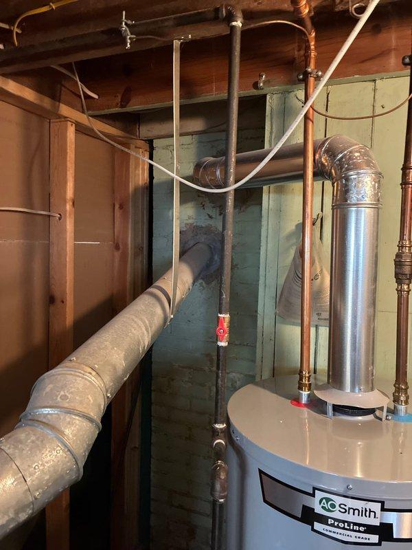 Conducted site assessment for furnace replacement options. Inspected exterior electrical connections housed in PVC conduit mounted to brick exterior wall. Evaluated utility area containing A.O. Smith ProLine water heater with associated exhaust venting and plumbing infrastructure. Presented repair alternatives alongside replacement recommendations for customer consideration.