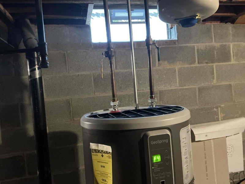 Conducted full system evaluation for furnace and AC replacement options. Inspected existing GeoSpring water heater system with digital controls and associated plumbing infrastructure. Examined PVC drainage configuration and evaluated current insulation conditions in utility area to determine optimal installation approach for new HVAC components.