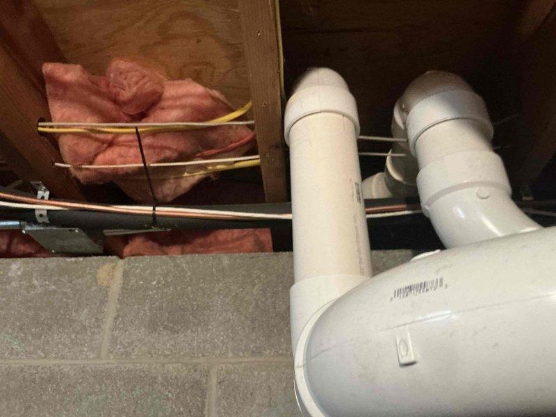 Conducted full system evaluation for furnace and AC replacement options. Inspected existing GeoSpring water heater system with digital controls and associated plumbing infrastructure. Examined PVC drainage configuration and evaluated current insulation conditions in utility area to determine optimal installation approach for new HVAC components.