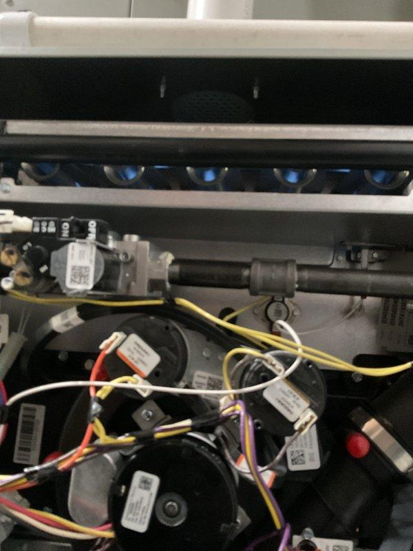 Performed scheduled maintenance on residential gas furnace system. Inspected burner assembly, gas valve components, and wiring connections for proper operation. Examined humidifier attachment and PVC ventilation system, confirming all components functioning within specifications.
