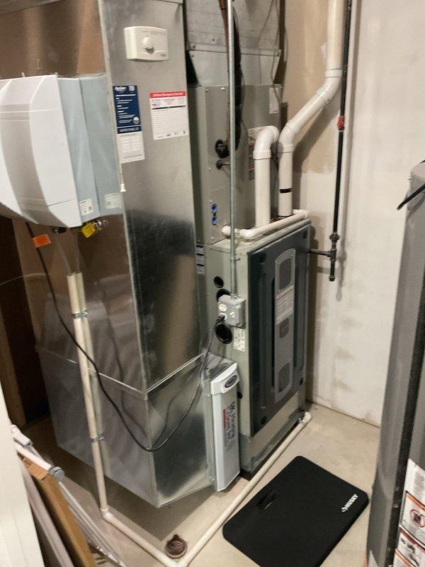 Performed scheduled maintenance on residential gas furnace system. Inspected burner assembly, gas valve components, and wiring connections for proper operation. Examined humidifier attachment and PVC ventilation system, confirming all components functioning within specifications.