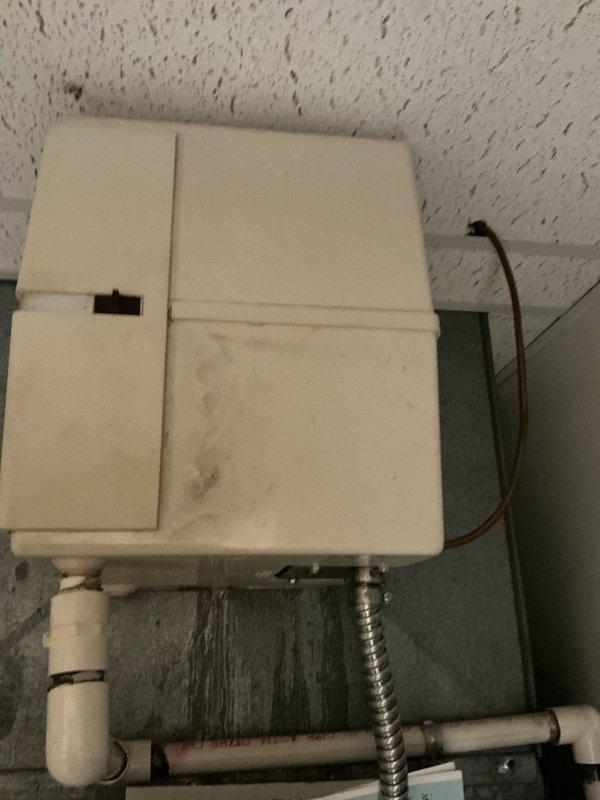 Conducted comprehensive assessment of rooftop heat pump unit requiring replacement, noting significant wear and water damage to the existing system. Observed deterioration of electrical connections including junction box mounted on wooden joists with visible moisture concerns. Documented conduit/flexible tubing condition and copper line positioning for proper replacement planning.