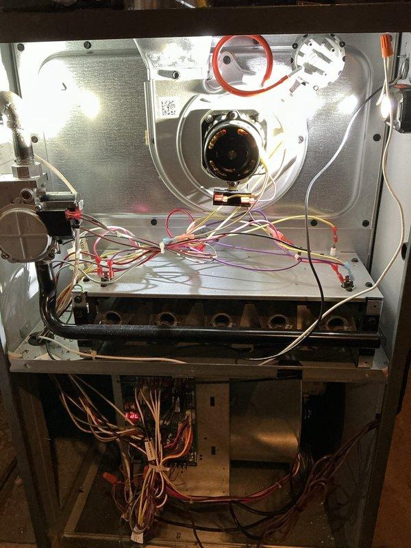 Completed scheduled heating maintenance service on gas furnace system. Performed comprehensive inspection of internal components including blower motor assembly, gas valve, burner assemblies, and control board connections. Examined whole-house humidifier mounted to ductwork and verified proper integration with HVAC system.
