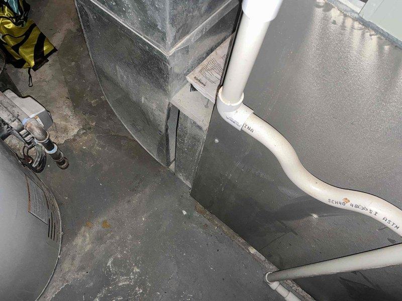 Conducted inspection of Lennox furnace system in utility area reporting "no heat" issue. Observed significant moisture accumulation on unit surface and documented existing installation including PVC intake/exhaust configuration. Provided customer with replacement options based on assessment of current system condition.