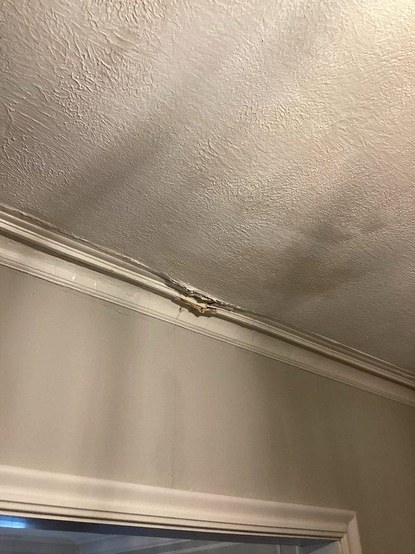 Responded to emergency water leak call where customer reported water leaking through first floor ceiling. Upon inspection, identified significant ceiling damage with exposed wooden structural elements. Investigated source of leak despite no bathroom directly above affected area, determined cause, and completed necessary repairs to prevent further water damage to ceiling and crown molding.