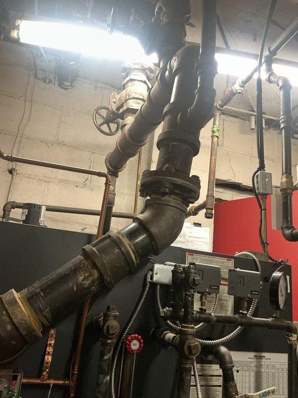Responded to a no-heat call for a boiler system. Upon inspection, found the water level was below the minimum operating level as indicated on the sight glass gauge. Refilled the system to proper operating parameters, bled air from lines, and verified proper ignition sequence. System is now functioning correctly and providing heat.