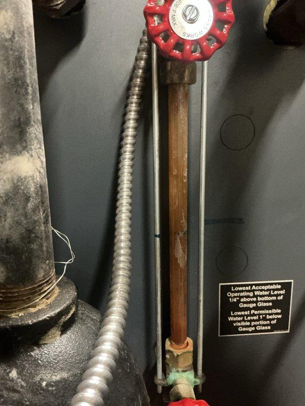 Responded to a no-heat call for a boiler system. Upon inspection, found the water level was below the minimum operating level as indicated on the sight glass gauge. Refilled the system to proper operating parameters, bled air from lines, and verified proper ignition sequence. System is now functioning correctly and providing heat.