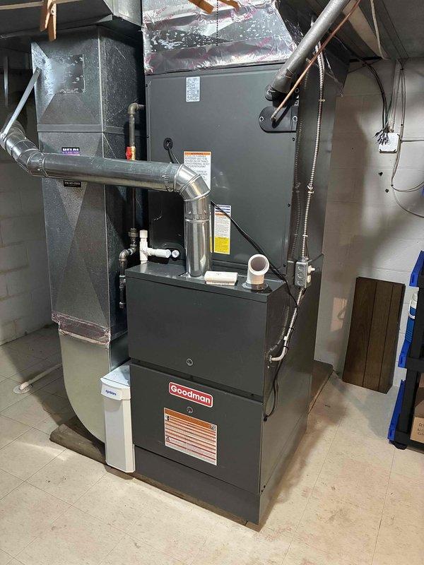 Completed installation of a Goodman 96% efficiency furnace with matching AC system. System includes properly connected ductwork with sealed plenum, PVC venting, and all required electrical components including Edison ECNR50 fuses for protection. Final inspection verified proper operation with all safety features functioning correctly.
