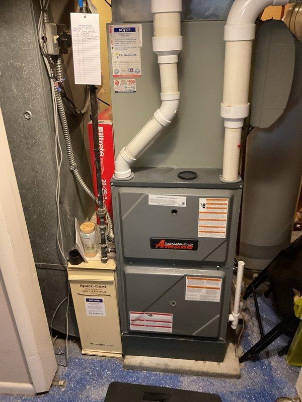 Performed scheduled preventative maintenance on residential furnace system. Inspected complete system including main heating unit, Space-Gard air cleaner, PVC ventilation components, gas connections, and condensate drainage. All components functioning properly with no issues identified during this routine maintenance visit.